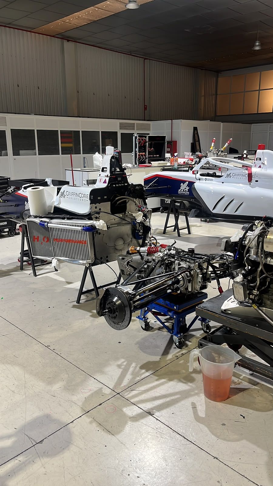 Formula car chassis stripped down on stands in the workshop