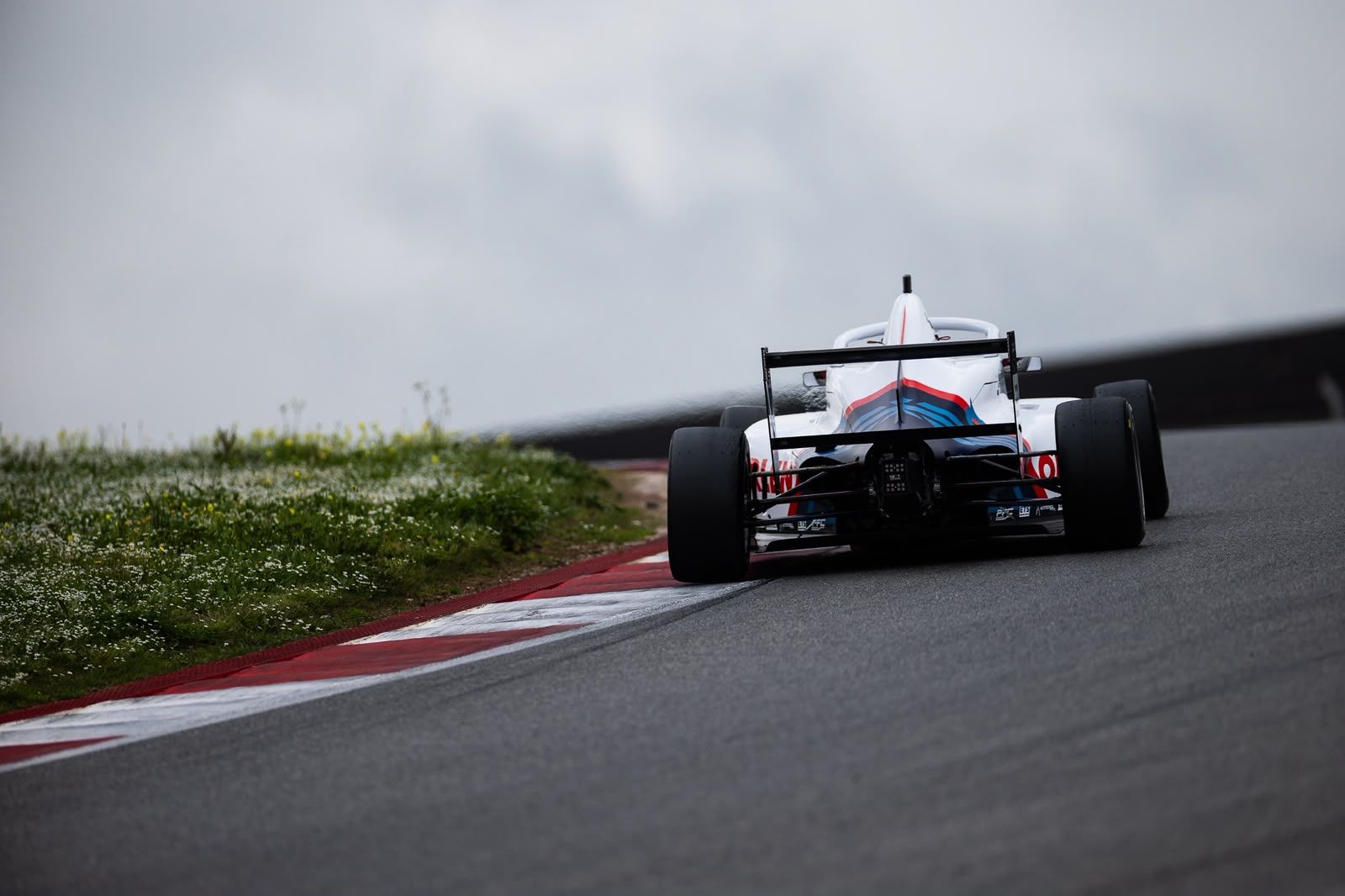 Rear view of a Formula 4 car on track
